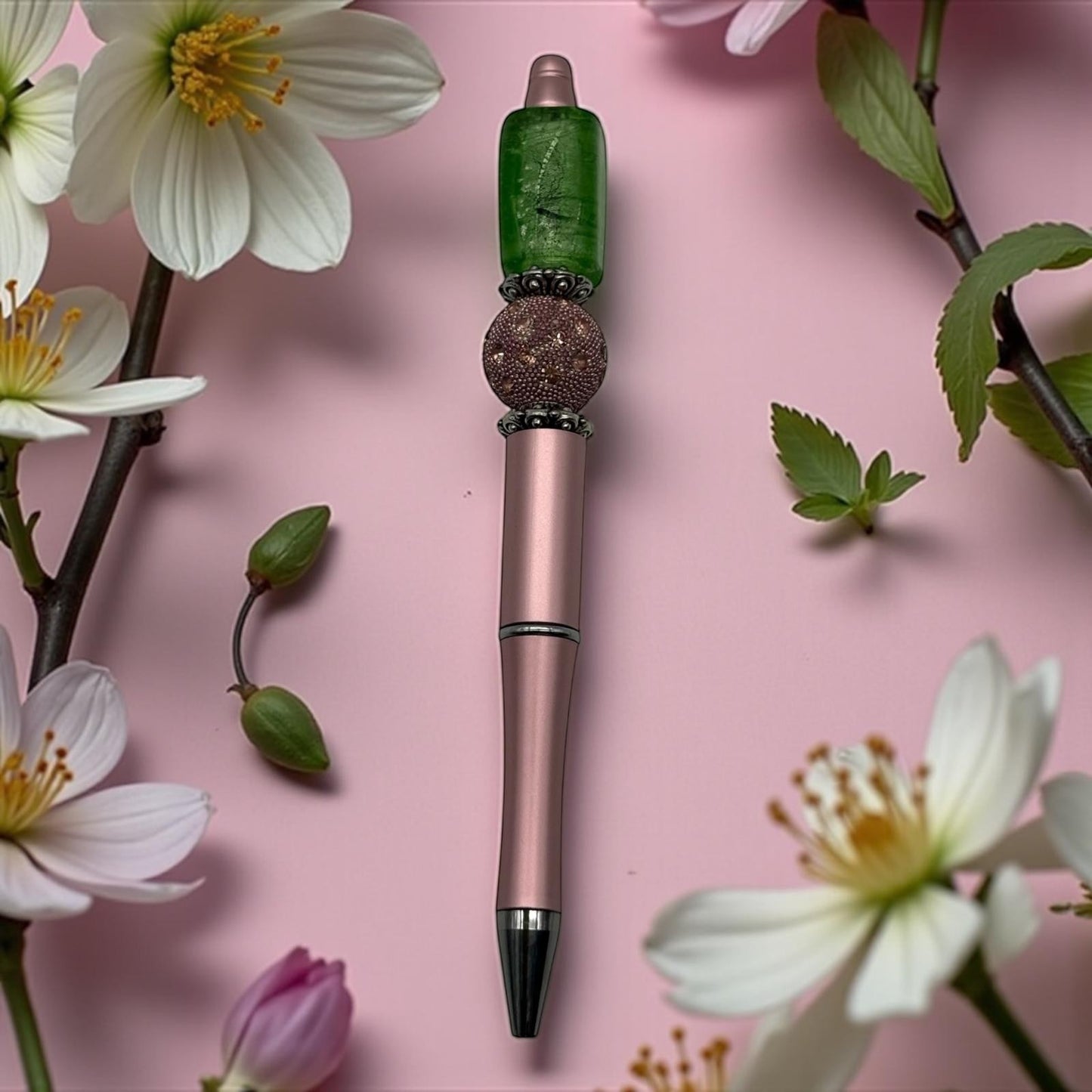 House of Lux Gifts handmade pink pen featuring a green rectangular lampwork glass bead and textured metallic accents.