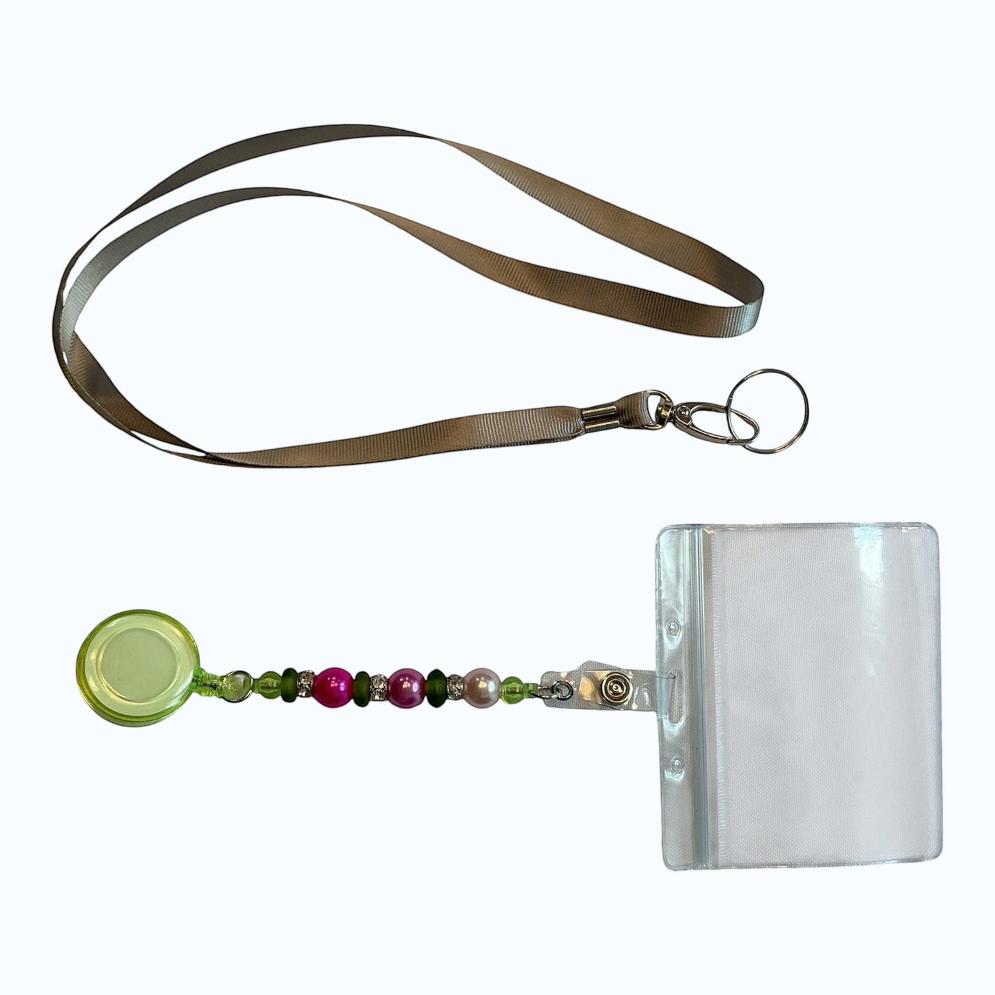 House of Lux Gifts retractable ID badge lanyard with pink and green beaded accents and a clear plastic card holder.