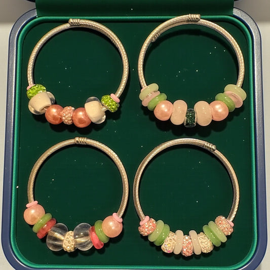 House of Lux Gifts handmade bangle bracelets featuring glass, rhinestone, and faux pearl beads in a green display box.