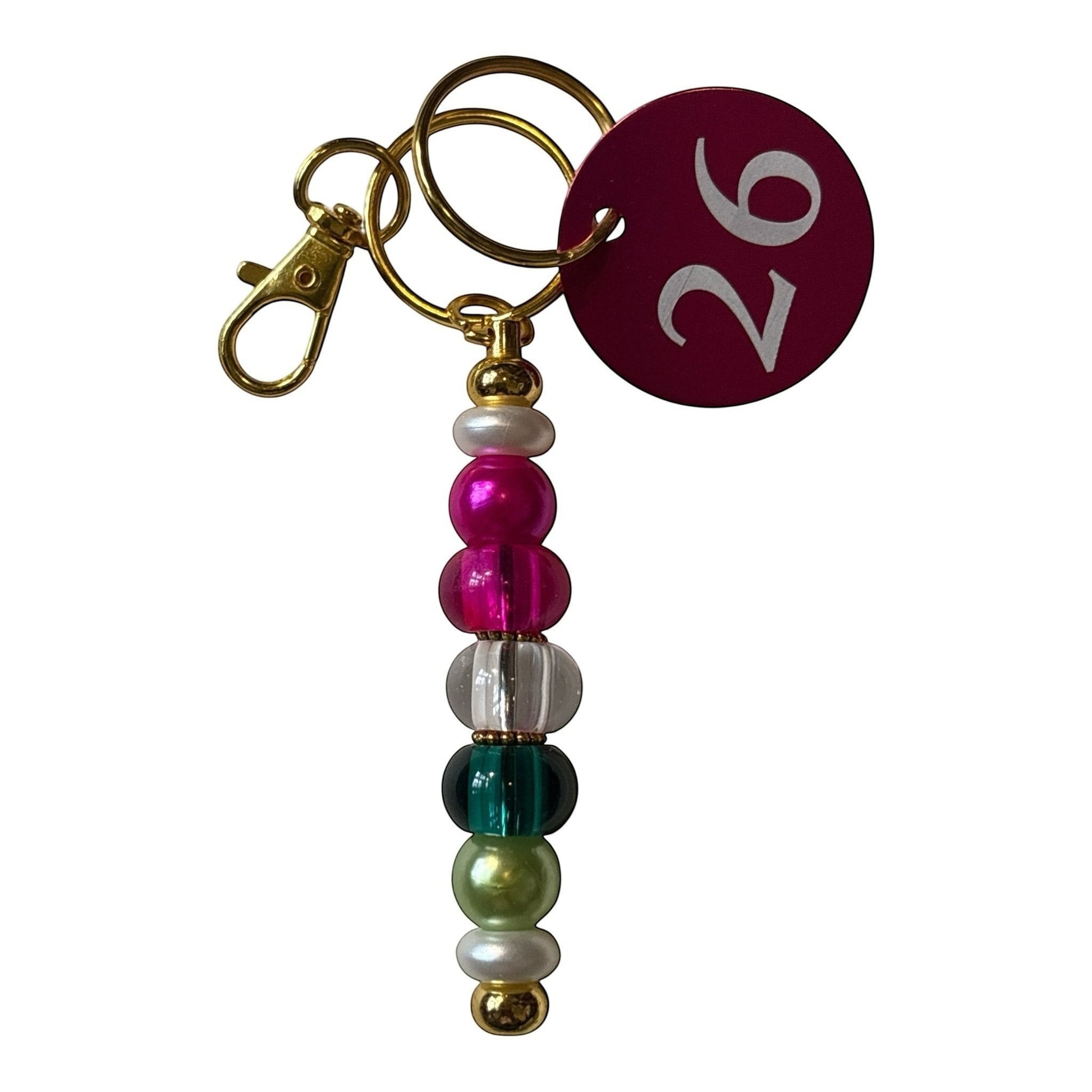House of Lux Gifts decorative beaded keychain with multi-colored beads, gold-tone hardware, and a numbered tag.