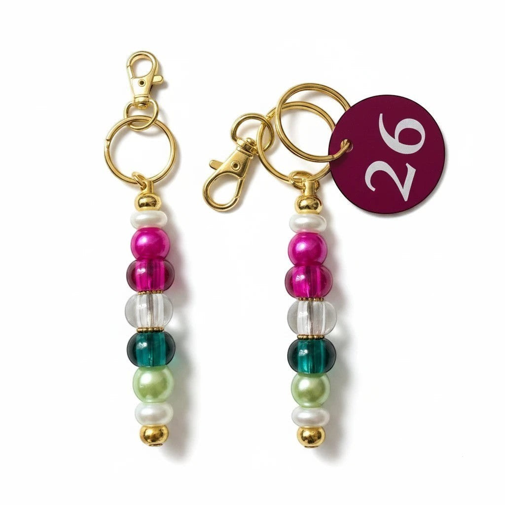House of Lux Gifts beaded keychain with hot pink, clear, emerald, and sage beads and gold-tone hardware
