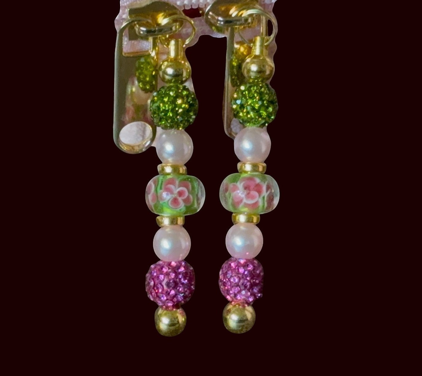 House of Lux Gifts handcrafted beaded zipper pulls with green, pink, and pearl accents on gold-tone hardware