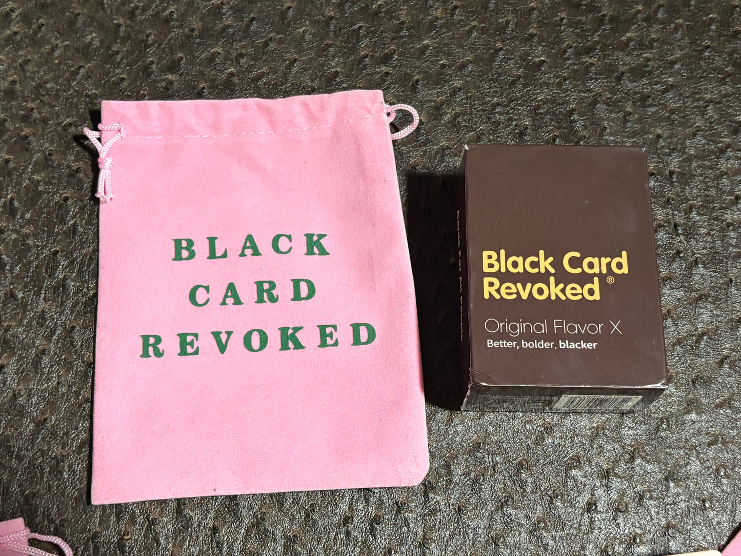 House of Lux Gifts Black Card Revoked game set with a pink velvet drawstring bag and card deck box