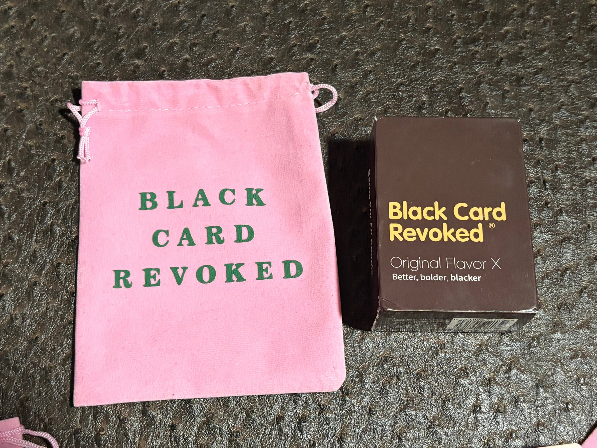 House of Lux Gifts Black Card Revoked game set with a pink velvet drawstring bag and card deck box