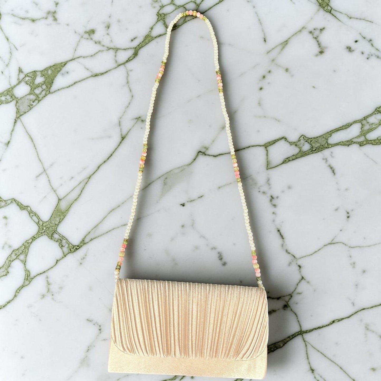House of Lux Gifts cream pleated evening clutch with a beaded shoulder strap featuring pink and green stone accents.