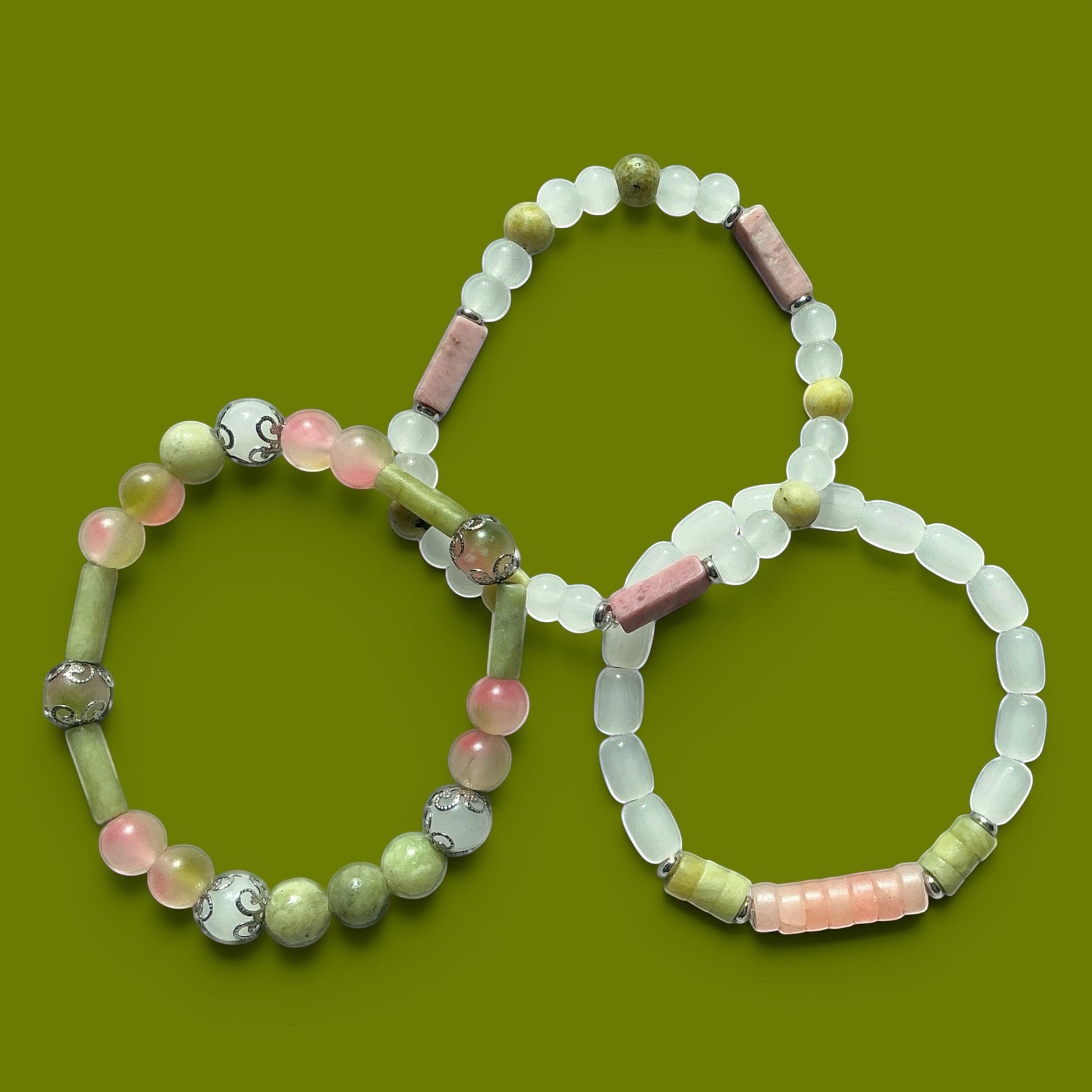 House of Lux Gifts artisanal stretch bracelets featuring mint green, olive, and blush pink gemstone beads.