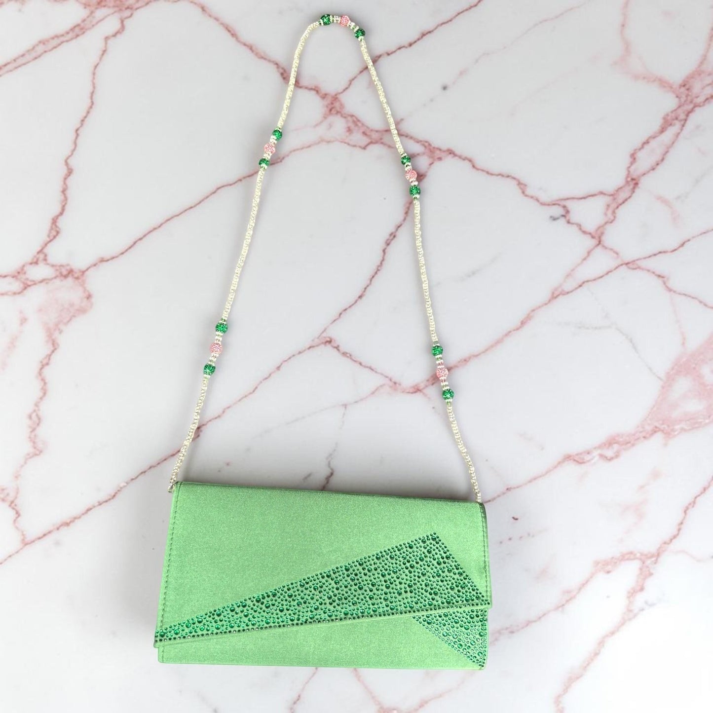 House of Lux Gifts green evening clutch with rhinestone accents and a detachable beaded pink and green shoulder strap.