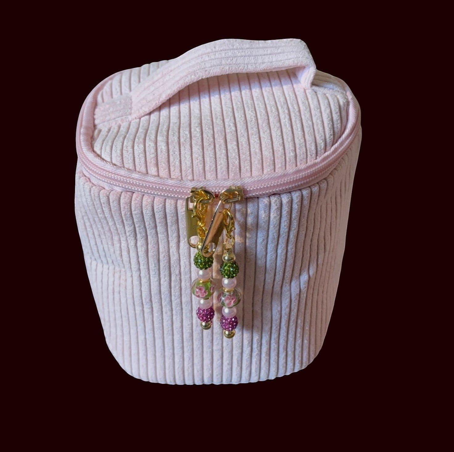 House of Lux Gifts blush pink ribbed corduroy round cosmetic bag with gold zippers and beaded pulls