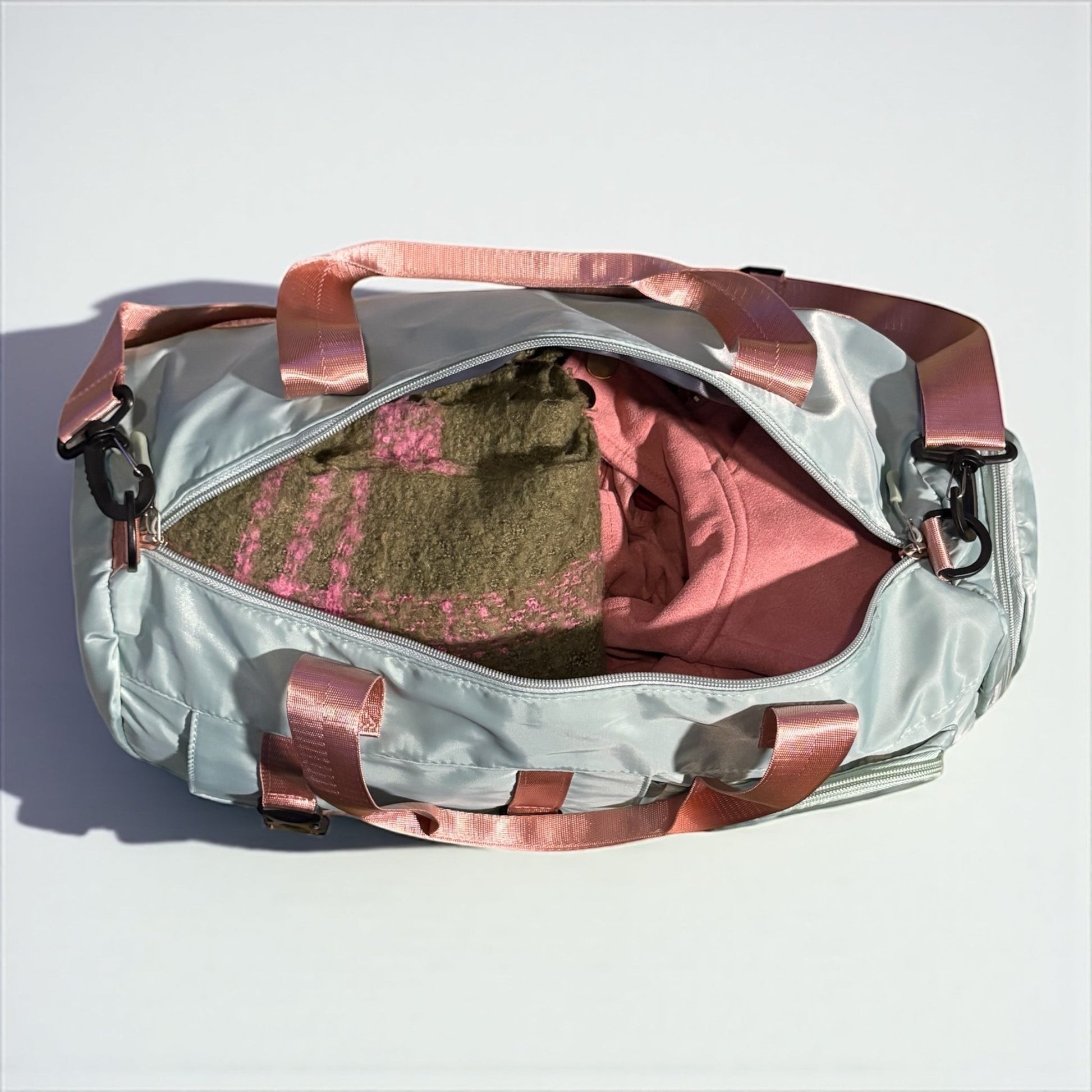 House of Lux Gifts pink and green duffel bag with top zipper, pink straps, and spacious interior for travel.