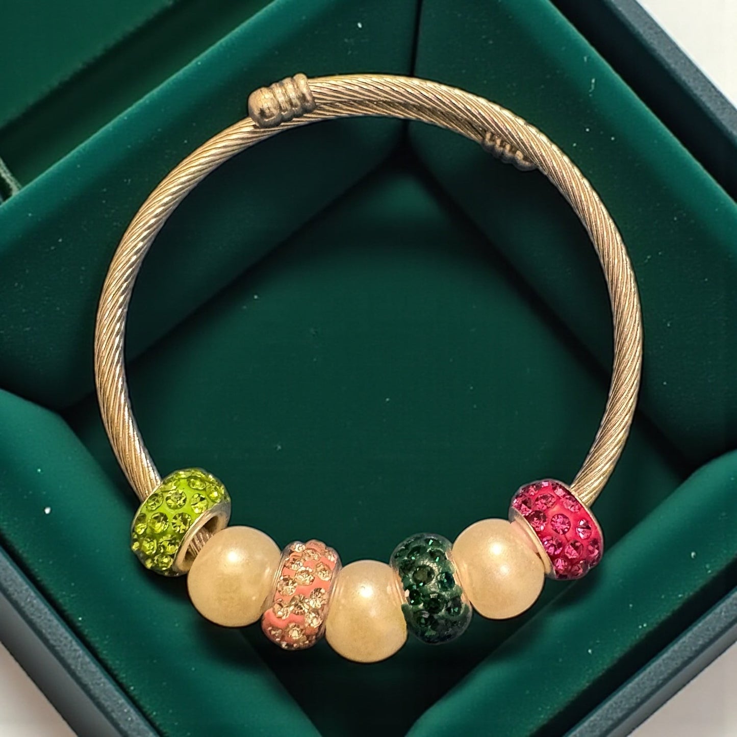 House of Lux Gifts handmade bangle bracelet with pink and green rhinestone beads and faux pearls on a twisted band.