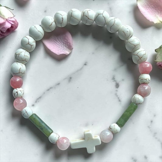 House of Lux Gifts handmade stretch bracelet with white turquoise beads, pink and green jade, and a white stone cross